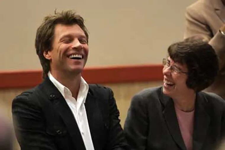 Singer Jon Bon Jovi shares a laugh with Sister Mary Scullion, executive director of Project HOME, during a Friday ceremony to establish a $3 million program to help homeless veterans in Philadelphia.