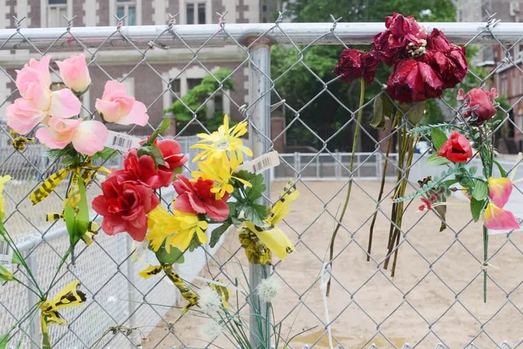 Flowers serve as a makeshift memorial for the victims of the building collapse at 22nd and Market Street in Center City, Philadelphia.  Jay Bryan and Nancy Winkler, who lost their daughter in the collapse, are working to create permanent memorial for the victims on the site.  (Andrew Thayer / Staff Photographer)