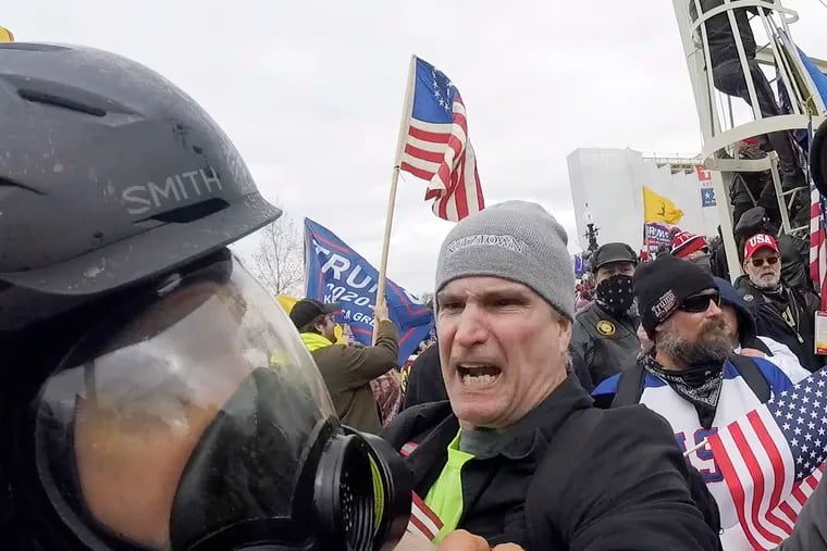 Alan William Byerly (center) attacks an Associated Press photographer during the riot at the U.S. Capitol in Washington on Jan. 6, 2021.