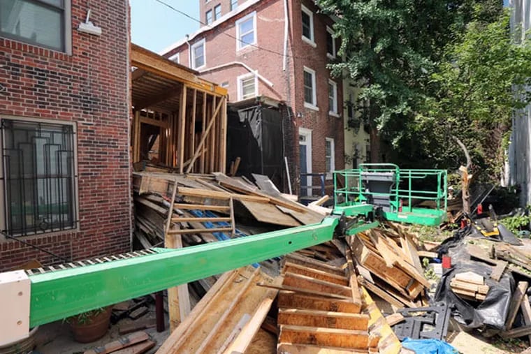 The collapsed row house at 320 Butler Ave. had been undergoing a partial demolition, and had been a sore point with neighbors and the city for years. (DAVID SWANSON / Staff Photographer)