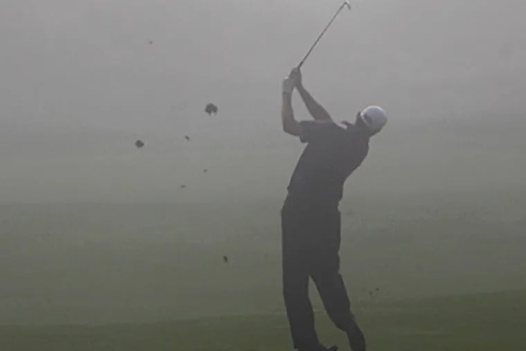 Bo Van Pelt hits a shot into the fog on the first hole during the first round of the PGA Championship.  (AP Photo/Jae C. Hong)