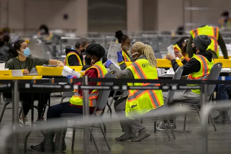Ballot counters count mail-in ballots at the Pennsylvania Convention Center on Wednesday, November 4.