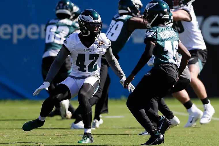 Eagles safety K'Von Wallace (left) defends against wide receiver Deontay Burnett in practice on Oct. 8.