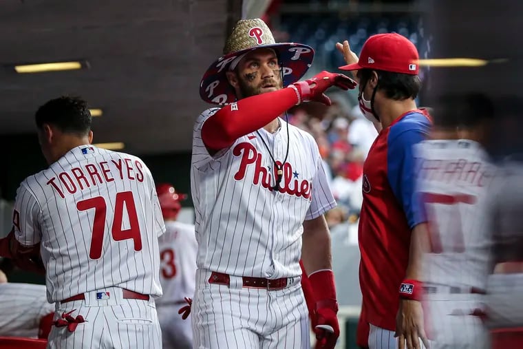 Phillies Bryce Harper celebrates with teammates in the dugout after hitting a solo homer against the Nationals during the 2nd inning at Citizens Bank Park in Philadelphia, Tuesday, June 22, 2021.