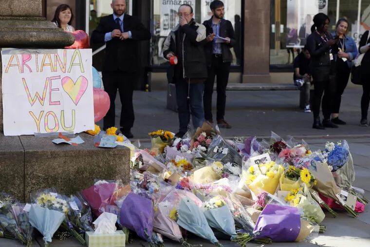 Floral tributes in Manchester, England, the day after the suicide attack at an Ariana Grande concert that left 22 people dead as it ended on Monday night. (AP Photo/Kirsty Wigglesworth)