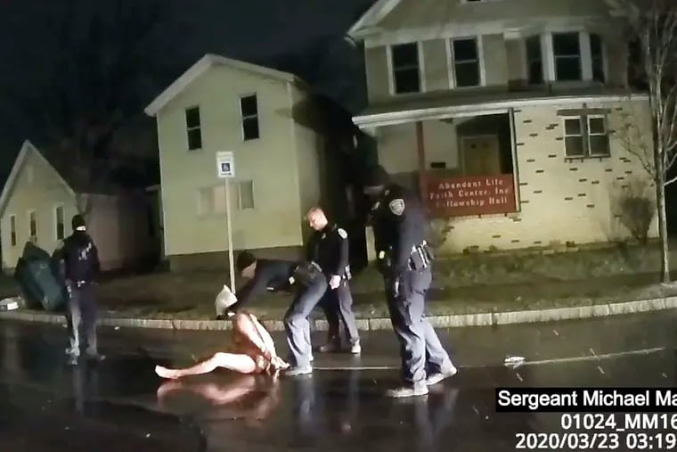 In this image taken from police body camera video provided by Roth and Roth LLP on Sept. 2, 2020, a Rochester police officer puts a hood over the head of Daniel Prude, on March 23, 2020, in Rochester, N.Y.