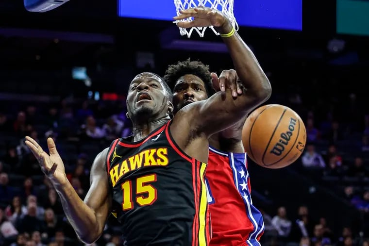 Sixers Joel Embiid blocks Hawks Clint Capela during the 4th quarter at the Wells Fargo Center in Philadelphia, Friday, December  8, 2023. Sixers beat the Hawks 125-114