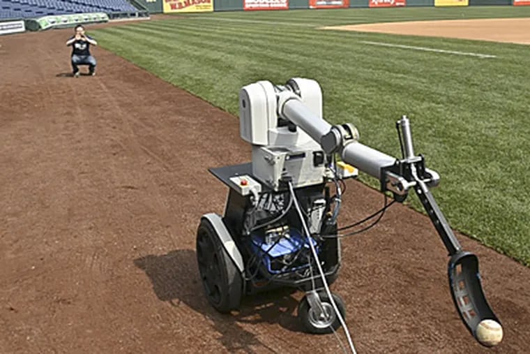 Penn's Jamie Gewirtz waits for PhillieBot to throw him a ball. The robot will deliver the first pitch for Wednesday's Phillies game against the Milwaukee Brewers. (Ron Tarver / Staff Photographer)