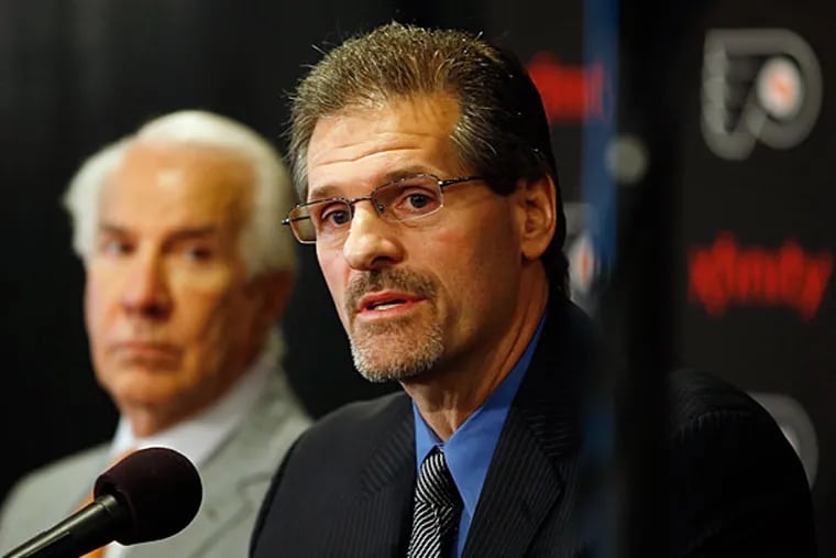 Ron Hextall, right, speaks as chairman Ed Snider looks on during an NHL hockey news conference, Wednesday, May 7, 2014, in Philadelphia. (Matt Slocum/AP)