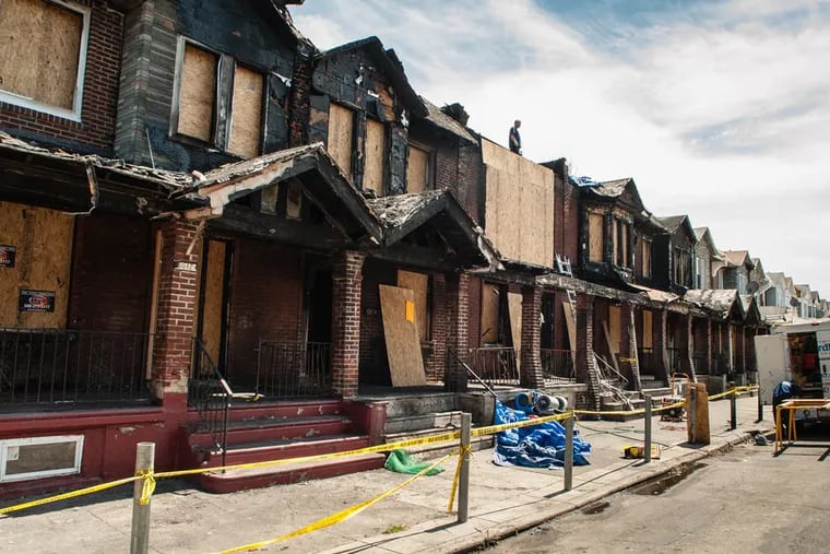Cleanup had begun on Gesner Street on July 6, 2014 after a fire damaged eight homes and claimed the lives of four children. ( MATTHEW HALL / Staff Photographer )