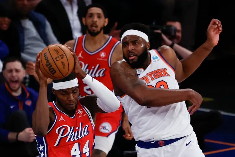 Sixers forward Paul Reed grabs a rebound against New York Knicks center Mitchell Robinson during Game 1.