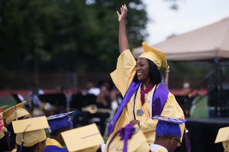 Ja'Nayzia Morris, Camden High's senior class president, waves to fellow graduates and parents at Camden High School's 2017 graduation ceremony, the last in the High's old building, June 20th, 2017. After more than 100 years in Camden's Parkside neighborhood, the Castle On The Hill will be torn down this summer, and will be replaced with a state-funded modern building.