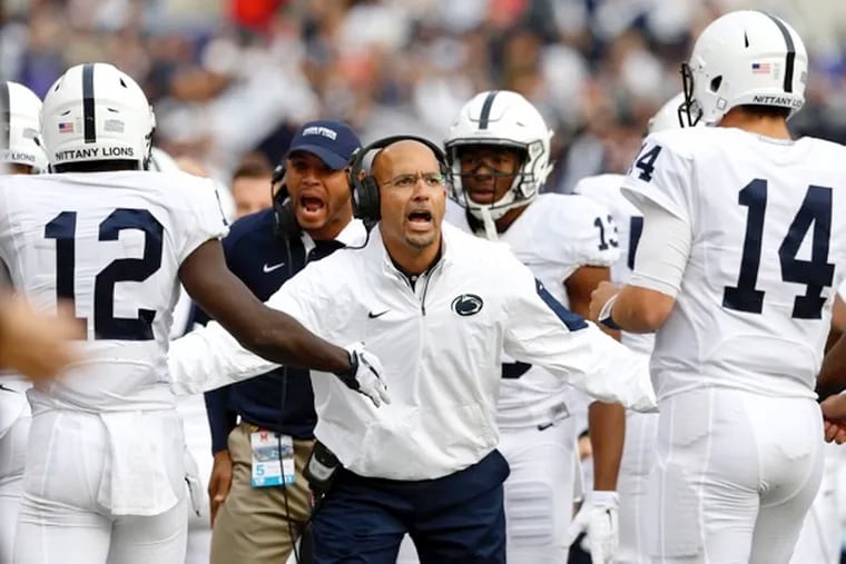 Penn State head coach James Franklin, center, greets wide receiver Chris Godwin, left, and quarterback Christian Hackenberg, right, as they jog off the field after a touchdown in the first half of an NCAA college football game against Maryland, Saturday, Oct. 24, 2015, in Baltimore.
