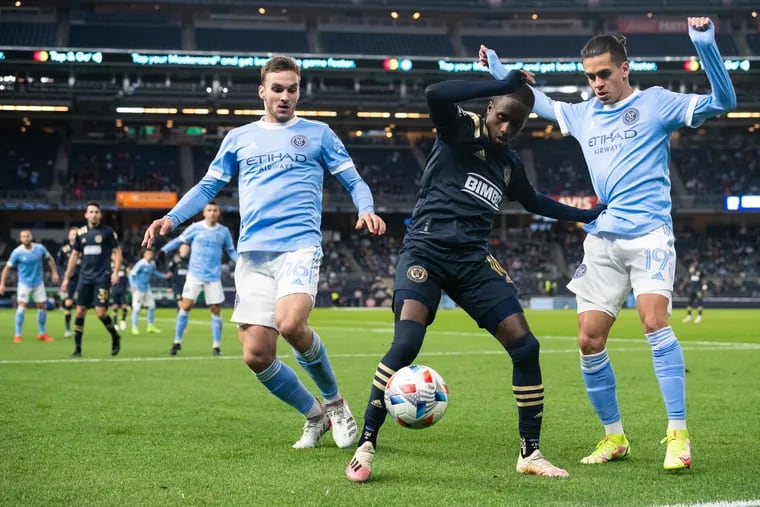 Jamiro Monteiro (center) tries to keep the ball under pressure from two New York City FC players during Sunday's 1-1 tie at Yankee Stadium.