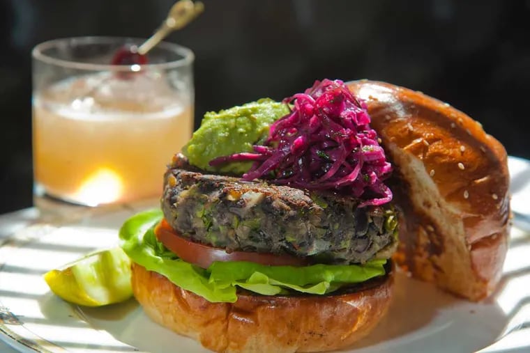 The Village Whiskey veggie burger is made from  black beans and lentils, carrots, onions, peppers, corn edamames, Swiss chard, cilantro, toasted cumin and corander seed and a little turmeric.  ( CLEM MURRAY / Staff Photographer )
