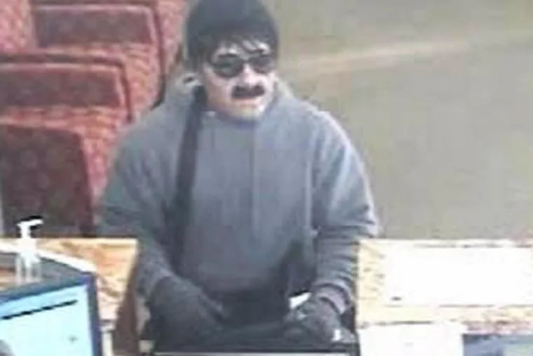 The "Inspector Clouseau bandit" at work at a Wells Fargo Bank branch in Wilmington.