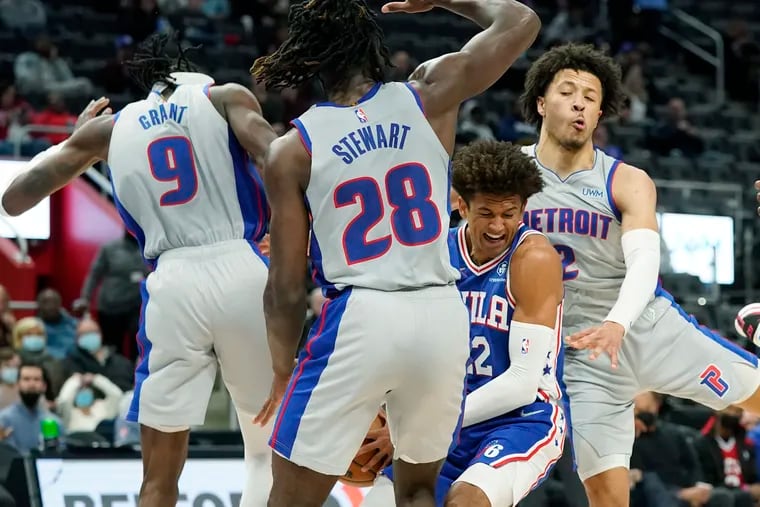 76ers guard Matisse Thybulle is surrounded by Detroit Pistons forward Jerami Grant, center Isaiah Stewart and guard Cade Cunningham during the second half.