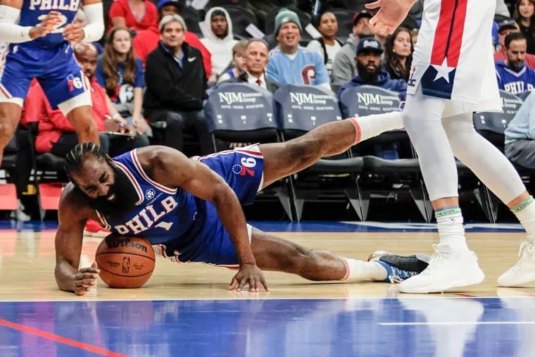 James Harden of the Sixers hits the court under Washington's Kristaps Porzingis during the first quarter at the Wells Fargo Center on Wednesday.