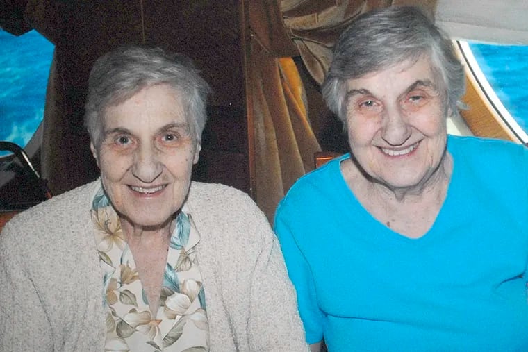 Doris Polsky (left) and twin sister Shirley Melvin in 2007. Together, they ran Twin Realty in Mount Airy. (APRIL SAUL / File Photograph)