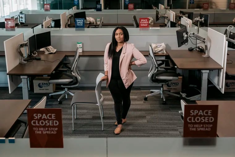 Amaiya Lockwood stands in her empty office during one of her first days back after working remotely from her apartment for over a year during the pandemic. Lockwood is a senior coordinator in claims administration at Zurich North America.   (Photo: William Widmer /  Washington Post News Service)