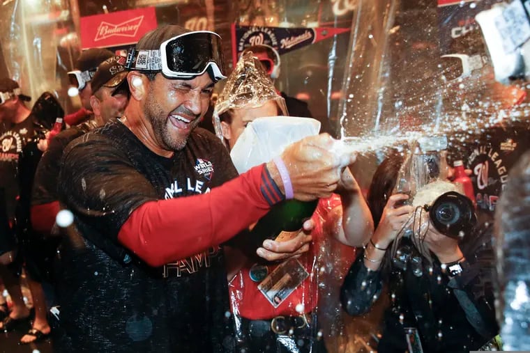 Washington Nationals manager Dave Martinez celebrates after his team swept the Cardinals.