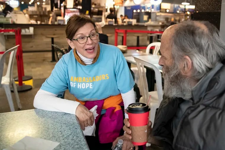 Teresa Giuliana, an ambassador of hope with Project Home, speaks with John Salvitti, who is homeless, at Reading Terminal Market. When vendors of the Reading Terminal had noticed an uptick in the number of homeless people in the market this spring, they turned to Sister Mary Scullion of Project HOME, who appointed Giuliana to be the ambassador at the terminal.  The program has made contact with 300 people in the past few months, placing 30 of them into housing and mental health services.