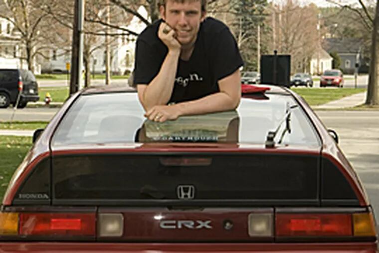 Benjamin Jones with his Honda at Dartmouth College. Jones runs ecomodder.com, a site dedicated to high fuel efficiency. (Joe Mehling)