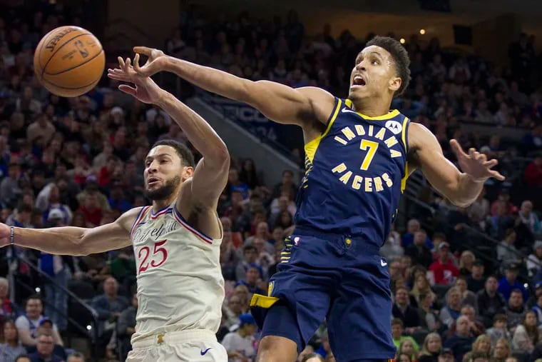 Ben Simmons, left, of the Sixers comes from behind to block a shot by Malcom Brogdon of the Pacers during the 2nd half at the Wells Fargo Center on Nov. 30, 2019.