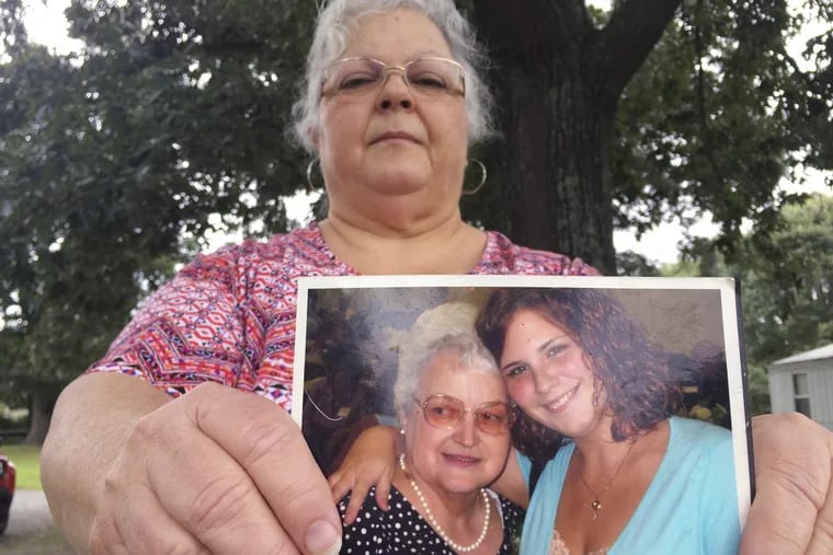 Susan Bro, the mother of Heather Heyer holds a photo of her and her daughter. Ms. Heyer was killed when police say a man plowed his car into a group of demonstrators protesting the white nationalist rally.
