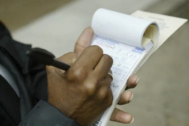 FILE - A Parking Authority employee writes tickets on Walnut Street.  (Jennifer Midberry/Daily News, File)