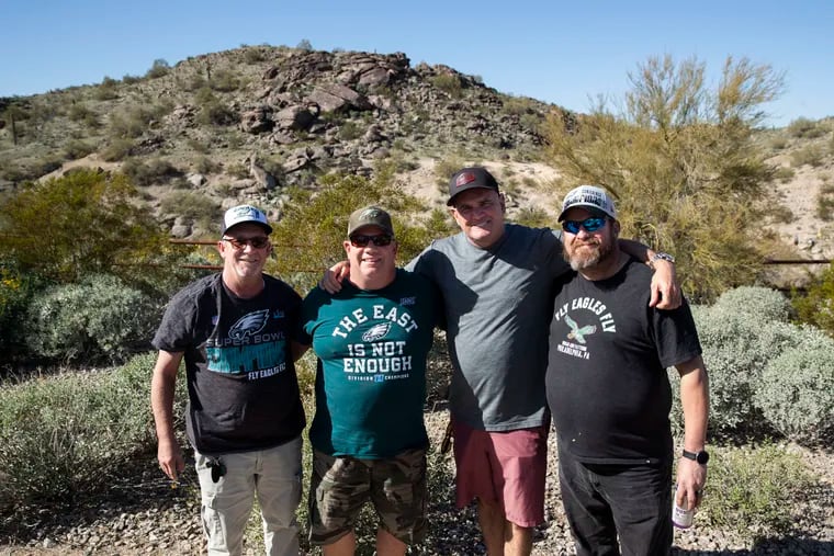 (From left) Tom (no last name given), Denny Alessandrine, Jim Wallin and Mike Daggett, all originally from Southwest Philadelphia, posed for a portrait at the Pima Canyon Trailhead in Phoenix on Wednesday, February 8, 2023. A number of Southwest Philly men in recovery have moved to Arizona to live a different sober life.