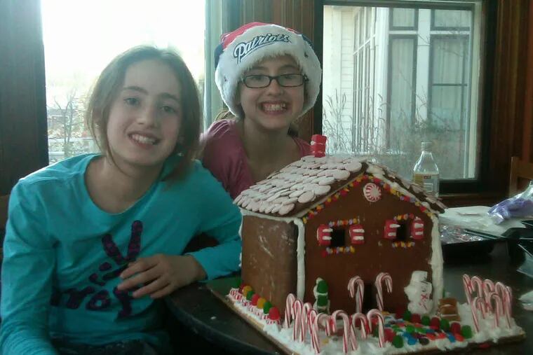 One of the finished products - a gingerbread house - is displayed by Zoe and Abby McElroy at Hotel Fauchere in the Poconos.