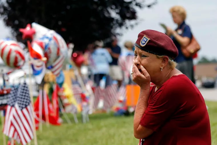 At a makeshift memorial outside a military recruiting center in Chattanooga, Tenn., that was the part of a shooting rampage that killed four Marines on Thursday, Laurie Norman grieves.
