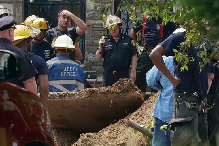 Firefighters try to rescue a man trapped in a trench in the 100 block of West Walnut Park Drive.