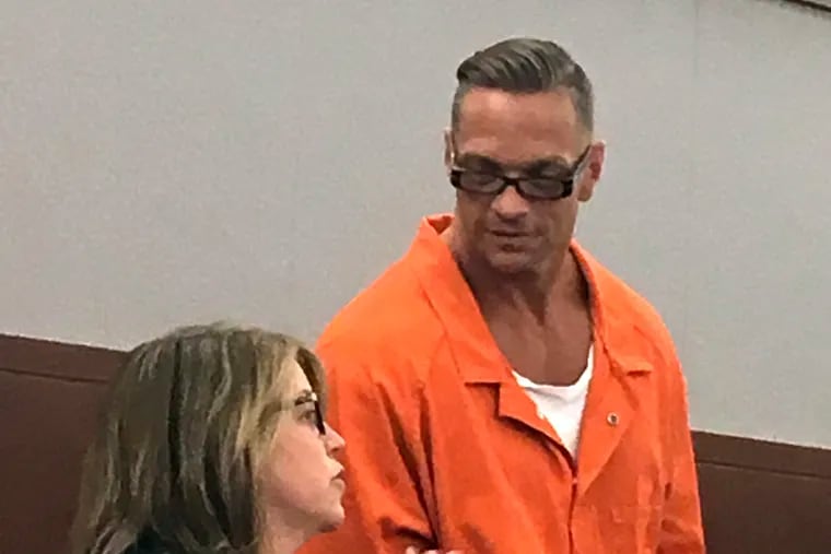 FILE - In this Aug. 17, 2017, file photo, Nevada death row inmate Scott Raymond Dozier, right, confers with Lori Teicher, a federal public defender involved in his case, during an appearance in Clark County District Court in Las Vegas. Authorities say the 48-year-old Nevada death-row inmate who wanted for two years to die, but whose execution was postponed twice, has been found dead in his cell on Saturday, Jan. 5, 2019, from an apparent hanging.  (AP Photo/Ken Ritter, File)