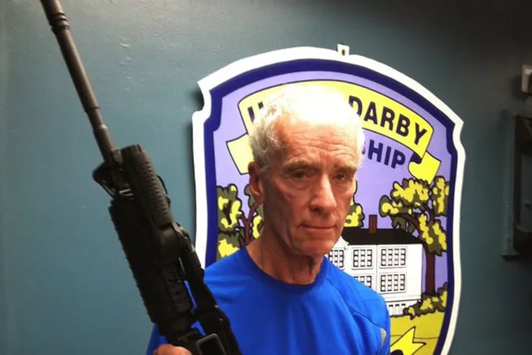 Upper Darby Police Superintendent Michael J. Chitwood holds up assault rifle Anthony Galla had when he was killed in a confrontation with police and U.S. marshals. (Photo: Mari Schaefer/Staff)