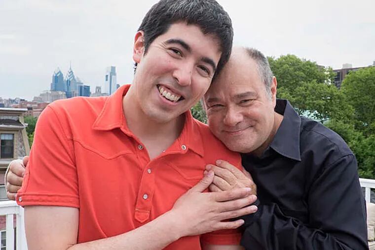 Newlyweds Mark Segal, publisher of the Philadelphia Gay News, and Jason Villemez (left) on the rooftop deck, with its Center City view, at their home in Society Hill.