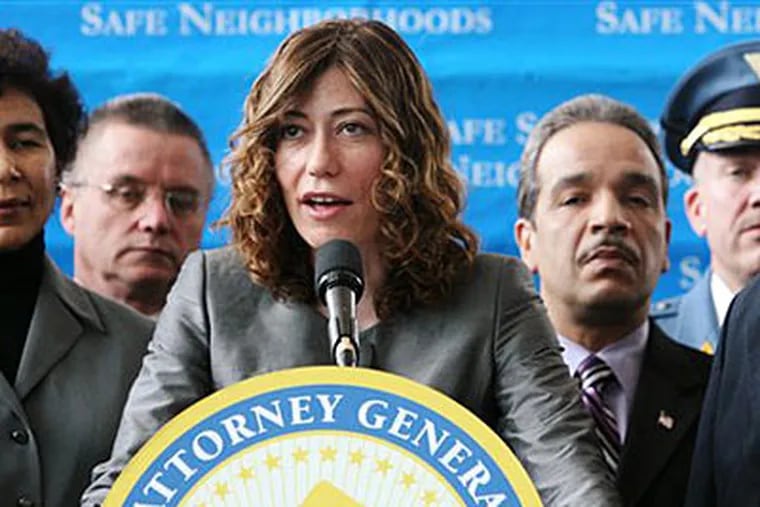 N.J. Attorney General Anne Milgram, accompanied by county prosecutors and other members of law enforcement, speaks at a news conference announcing that an anti-gang initiative has netted more than 1,800 arrests as well as the seizure of narcotics and guns.  (AP Photo/The Record, Chris Pedota)