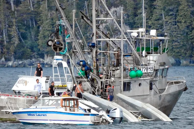 This Monday, May 20, 2019, photo provided by Aerial Leask shows good Samaritans attempting to bring in a floatplane that crashed in the harbor of Metlakatla, Alaska. Officials said the pilot and passenger aboard the plane died, and the National Transportation Safety Board is investigating the crash. (Aerial Leask via AP)