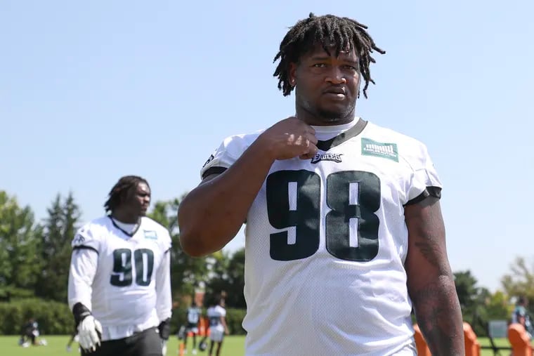 Eagles defensive tackles Jalen Carter (front) and Jordan Davis exit the field after practice on the second day of open training camp at the NovaCare Complex in Philadelphia on Friday, July 28, 2023.