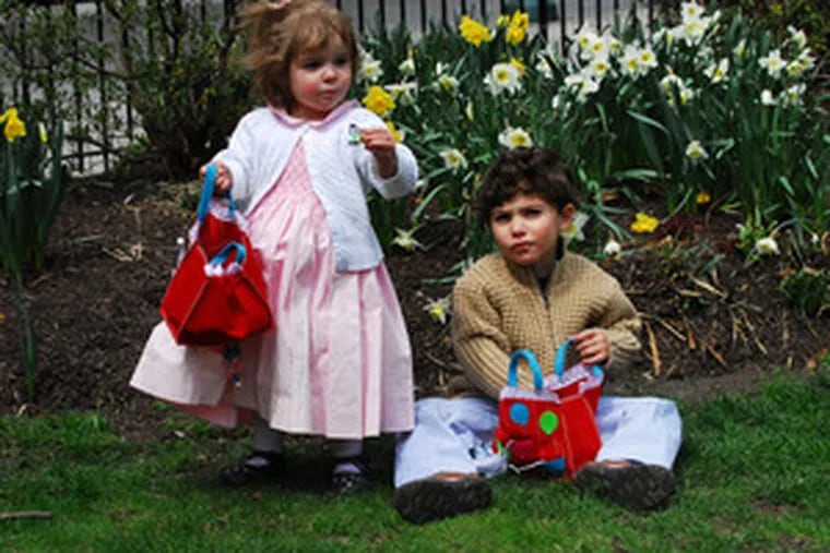 Sophia Murray , 2, and brother William, 4, of Philadelphia hunted for candy after church in Rittenhouse Square.