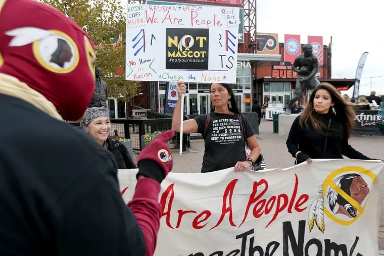 Jon Foster, at left, a former DC resident, argues as a group protests over the Washington Redskins team name and mascot outside Lincoln Financial Field before the Philadelphia Eagles play the Washington Redskins in Philadelphia, PA on October 23, 2017. DAVID MAIALETTI / Staff Photographer
