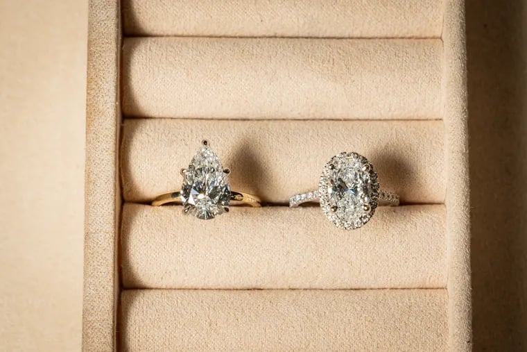 At L. Priori Jewelry, a pear-shaped lab diamond on the left and an oval-shaped mined diamond on the right.