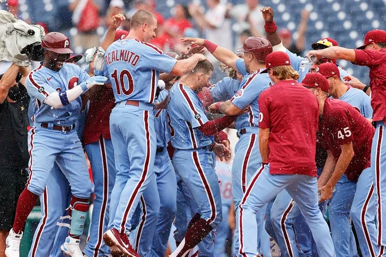 The Phillies' Brad Miller (center) celebrating his walk-off grand slam with his teammates against the Washington Nationals in Game 2 of a July 29 doubleheader.