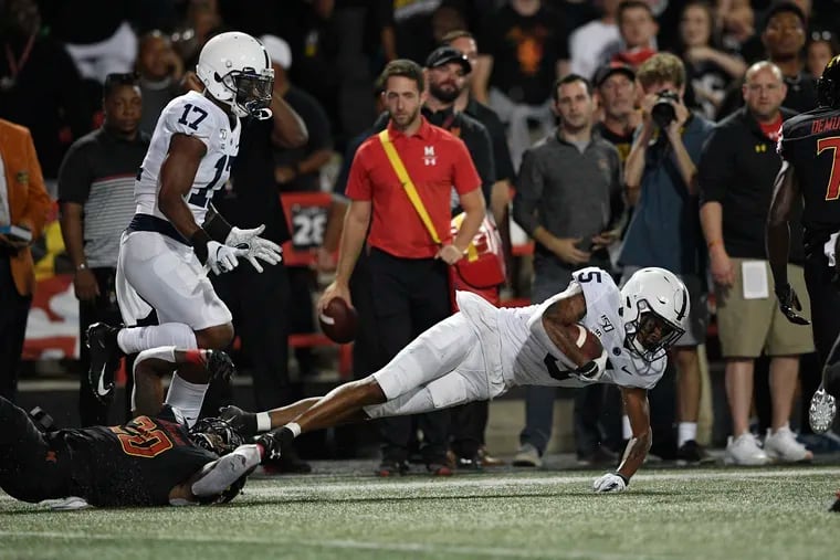 Penn State cornerback Tariq Castro-Fields (5) falls to the ground after intercepting a pass during the first half of an NCAA college football game against Maryland.