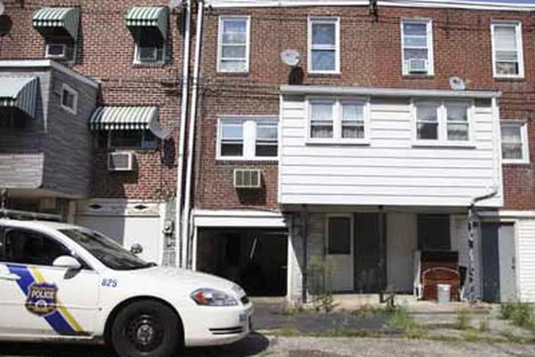Rear view of rowhouse where abducted storeowner was tortured. (JOSEPH KACZMAREK / For the Daily News)