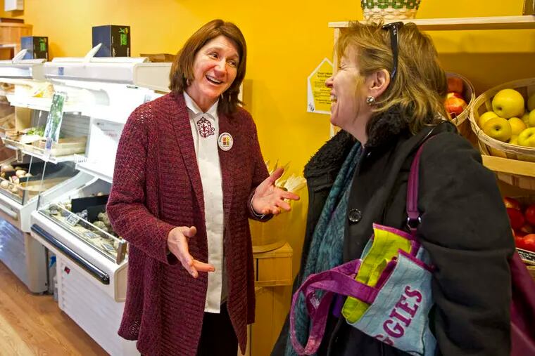 Lisa White (left), an organizer of the co-op, chats with a shopper. The store has had a soft opening before its official debut.