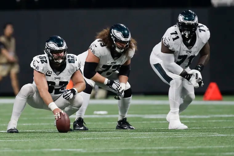 Eagles offensive linemen Jason Kelce (left), Isaac Seumalo (center) and Jason Peters at work Sunday night in Atlanta.
