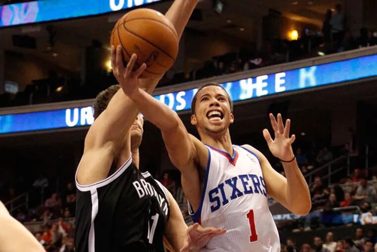 Michel Carter-Williams drives on the Nets' Brook Lopez. (Ron Cortes/Staff Photographer)