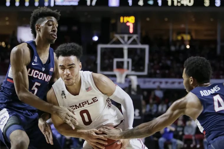 Temple's # 0 Obi Enechionyia splits UConn's # 5 Isaiah Whaley and # 4 Jalen Adams as he goes to the net in the first half of the Univ of Conn. at Temple University Mens college basketball game at Temple's Liacouras Center in Phila., Pa. on January 28, 2018. ELIZABETH ROBERTSON / Staff Photographer